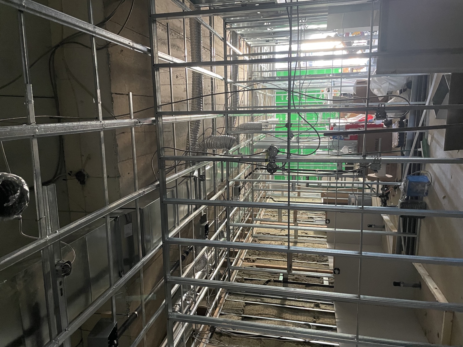 Metal stud framing, ceiling grid and mechanical rough-in during a commercial tenant improvement construction project