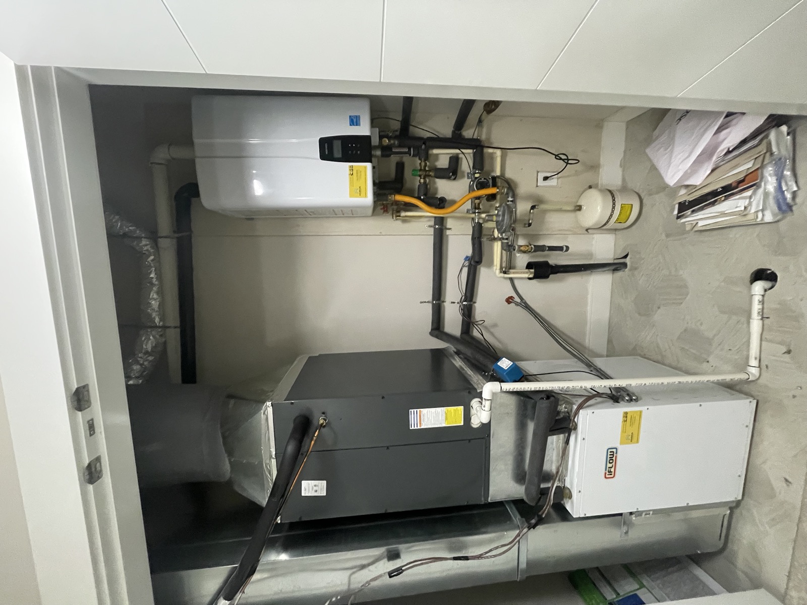 Navien tankless water heater combined with an iFlow air handler installed in a utility closet