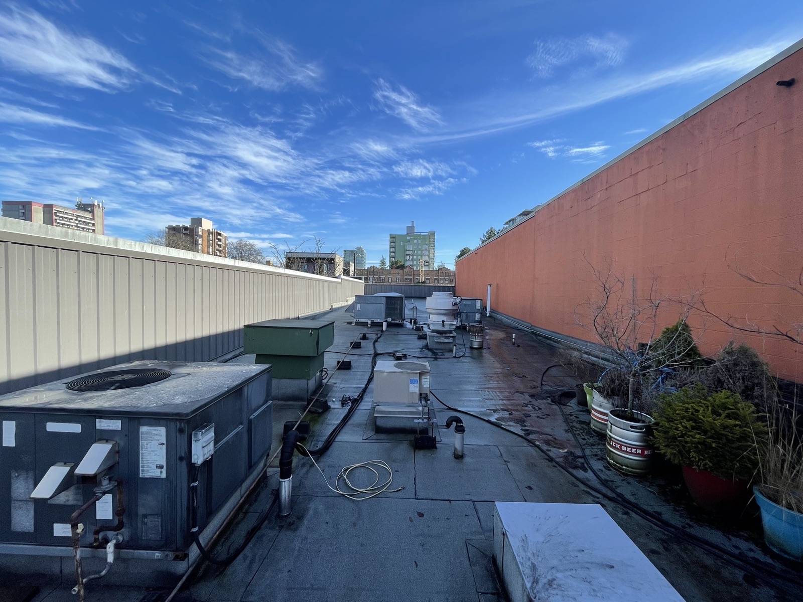 Rooftop commercial HVAC units being serviced on a Vancouver building rooftop